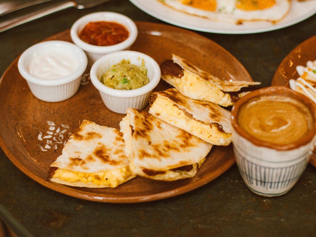 Delicious quesadillas served with salsa, guacamole, and coffee. Perfect brunch option.